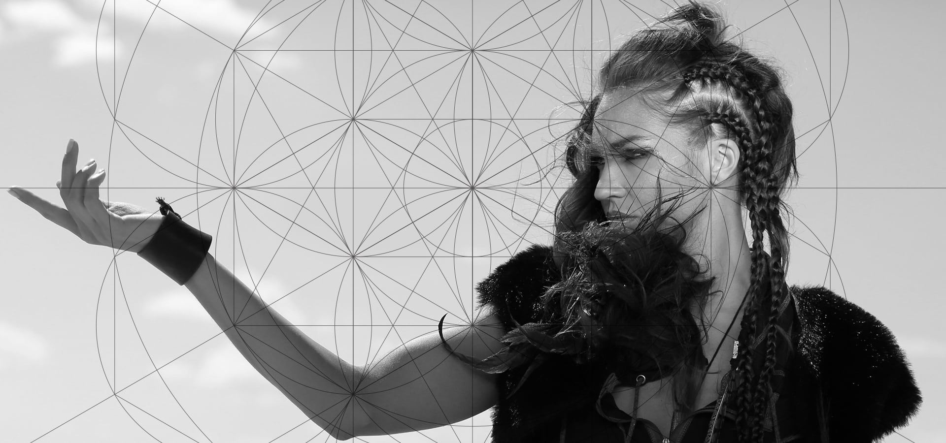 Black and white photo of a woman with braids and a fur jacket, overlaid with geometric shapes, reaching out with her hand.